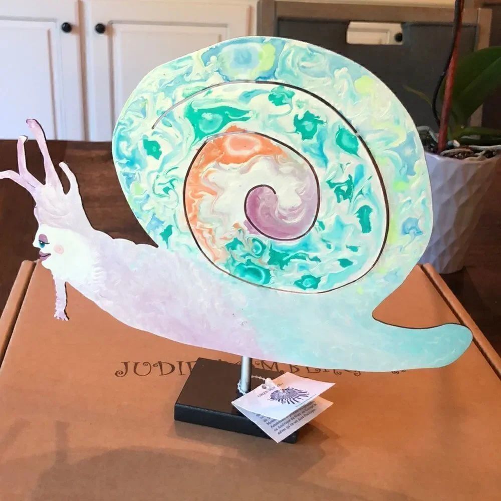 Hand signed “Alice the Snail” Cirque du Soliel metal art piece.